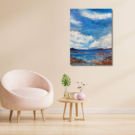 Original acrylic painting (18 by 24 inch) of a coastal scene with rocky shore and blue sky with clouds by Ottawa-based artist Mireille Laroche hung on a wall