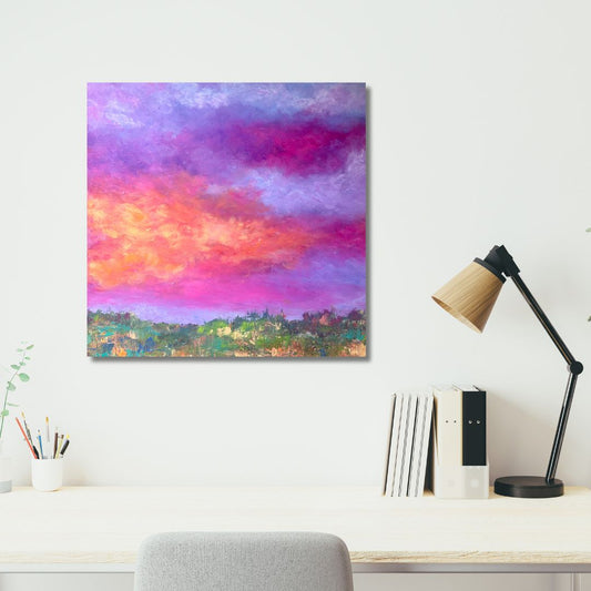 Colorful semi-abstract painting by Ottawa artist Mireille Laroche on a wall above a desk with a lamp and books.
