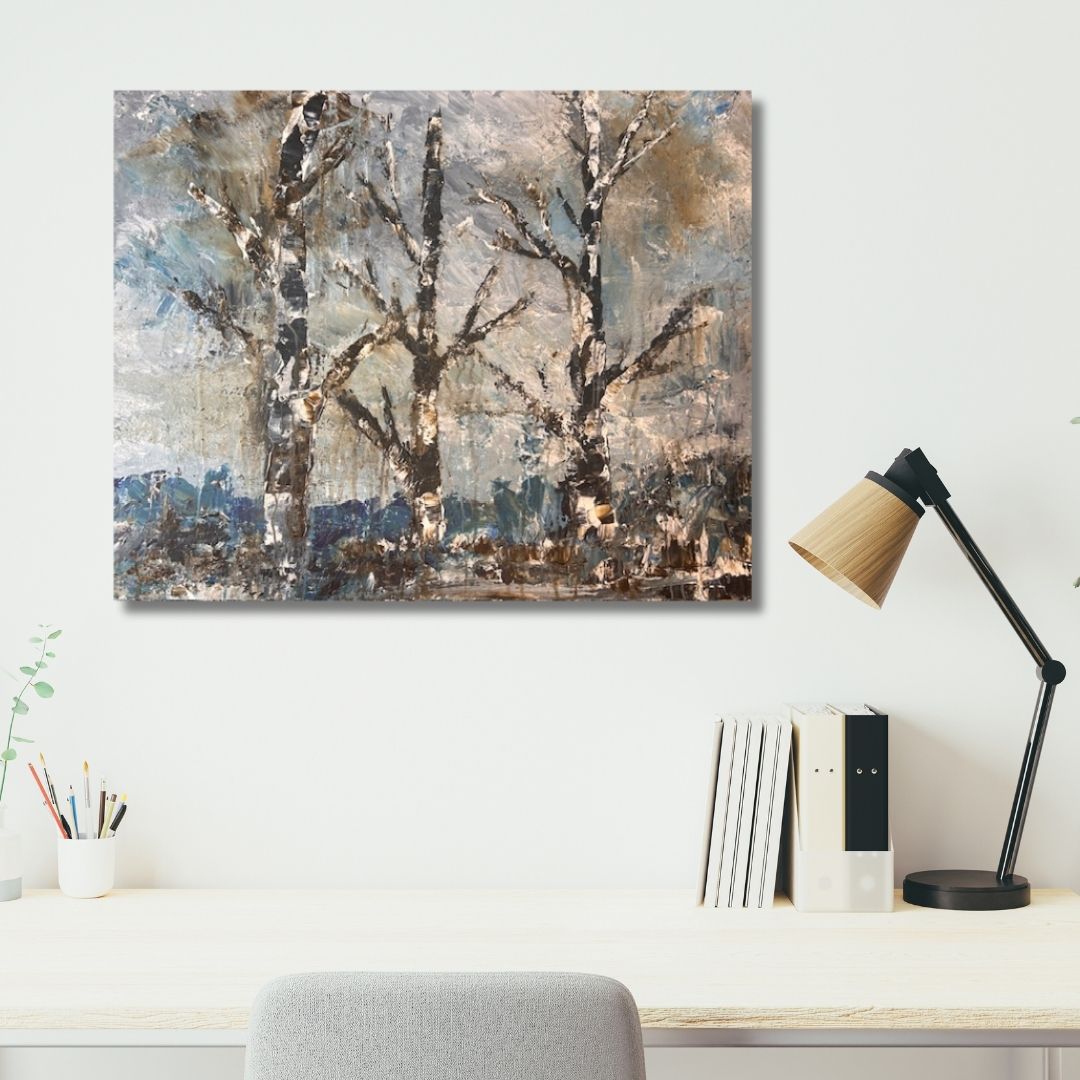 Abstract painting of trees by Ottawa artist Mireille Laroche on a wall above a desk with a lamp and books.