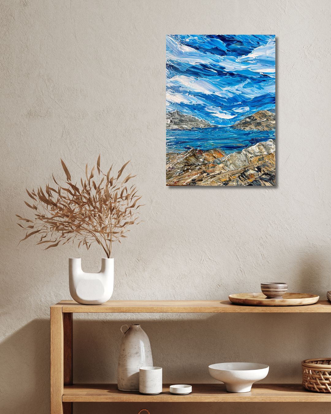 Original 9 by 12 inch acrylic painting on a 1.5 inch deep canvas by Ottawa artist depicting a seaside landscape.  Painting on a beige wall above a shelf with decorative items