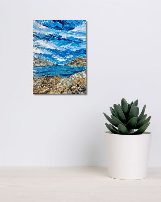Original 9 by 12 inch acrylic painting on a 1.5 inch deep canvas by Ottawa artist Mireille Laroche depicting a seaside landscape.  Painting on a white wall above a shelf with a plant.