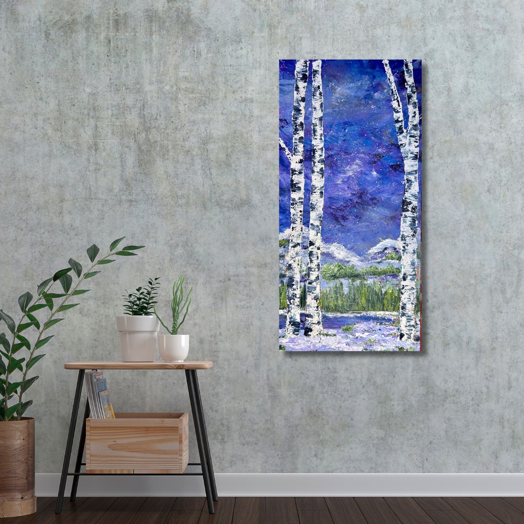 Painting of birch trees on a wall above a wooden side table with plants.