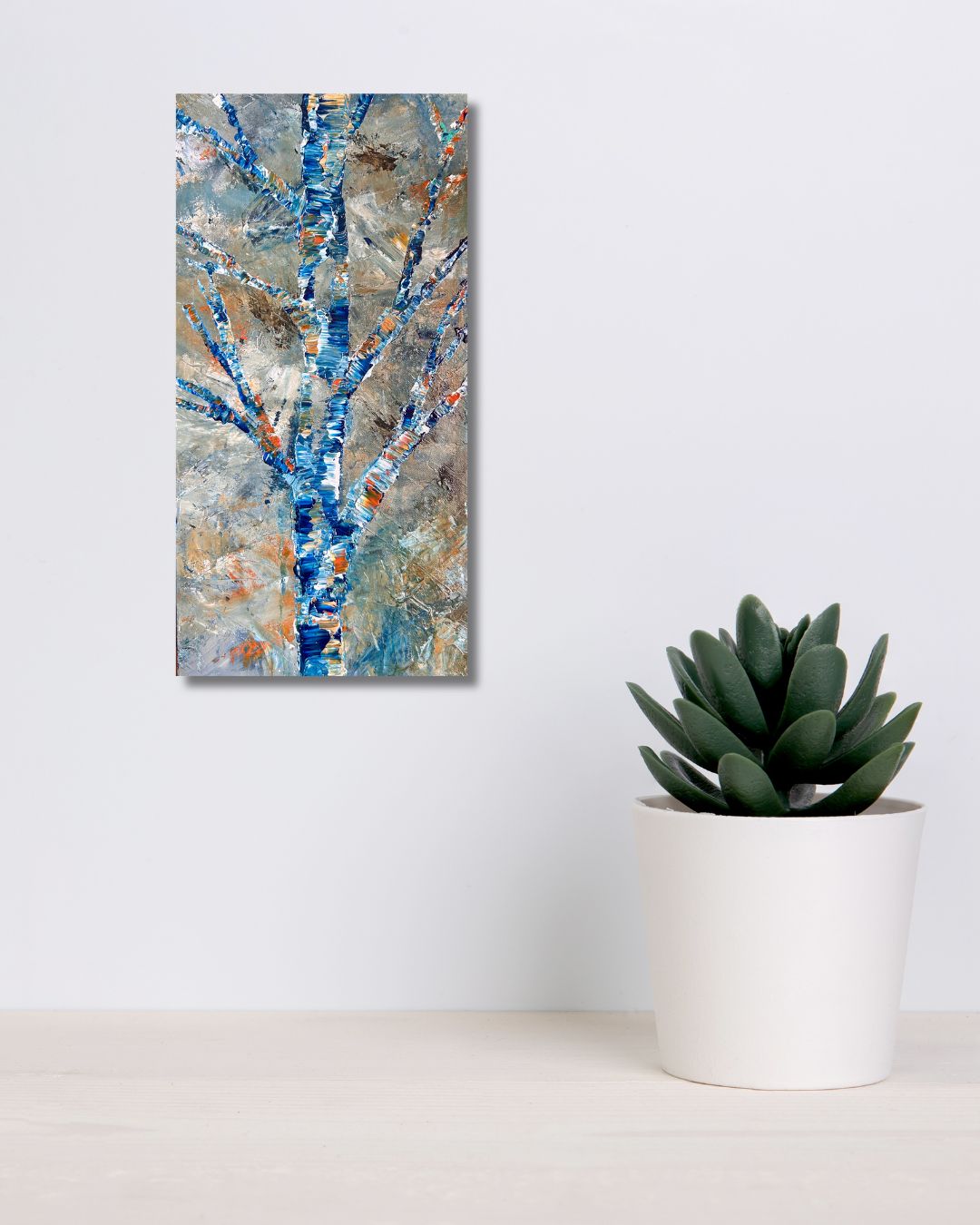 Original acrylic painting by Ottawa artist Mireille depicting a semi-abstract tree.    Painting on a white wall above a shelf with a plant