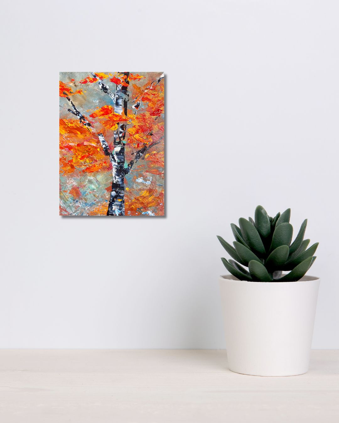 Original 9 by 12 inch acrylic painting on a 1.5 inch deep canvas by Ottawa artist Mireille Laroche  depicting a semi-abstract tree.  Painting on a white wall above a shelf with a plant