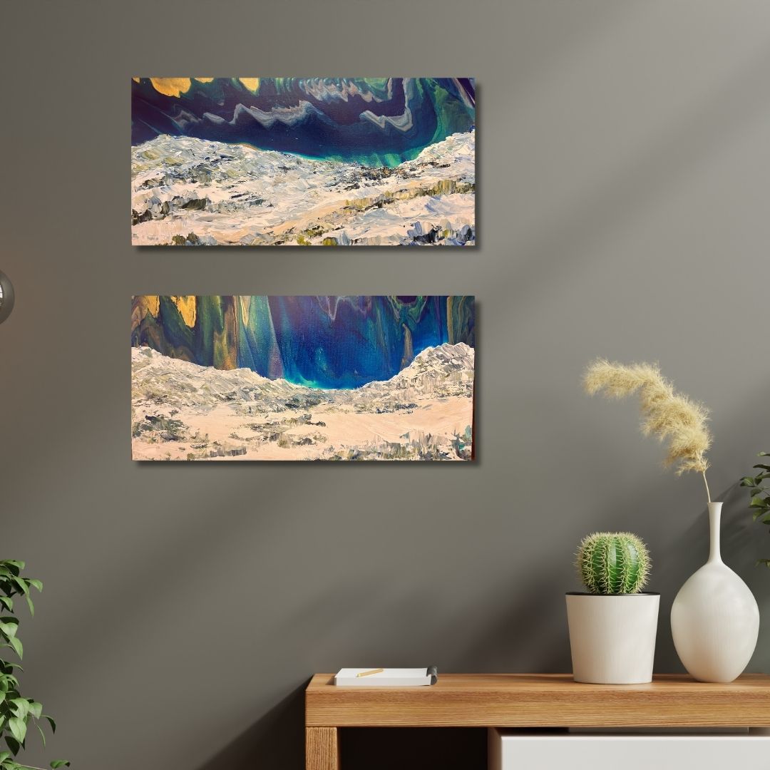Two abstract paintings on a wall above a wooden console table with decorative items.
