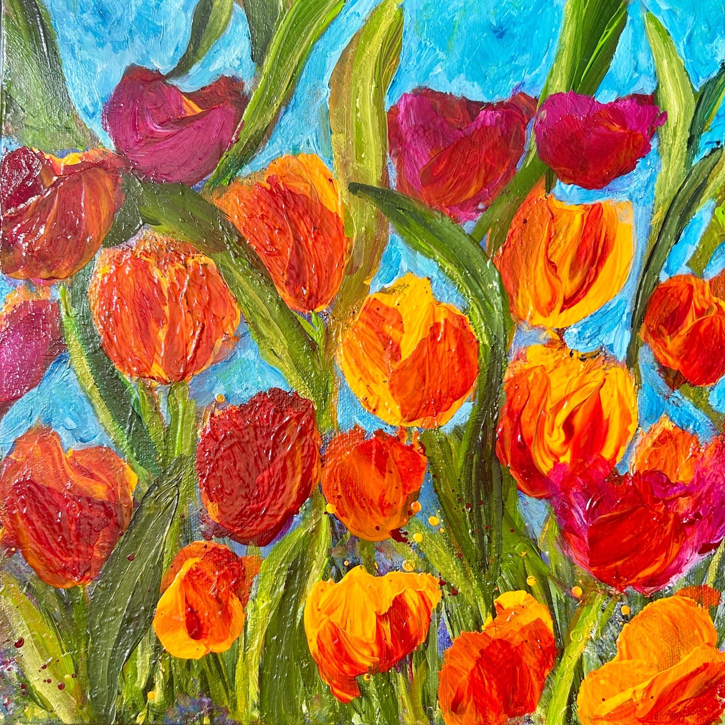 Colorful tulip painting with red, orange, and pink flowers on a blue background. Original acrylic painting 12 by 12 inch on a 1.5 inch deep canvas by Ottawa-based artist Mireille Laroche