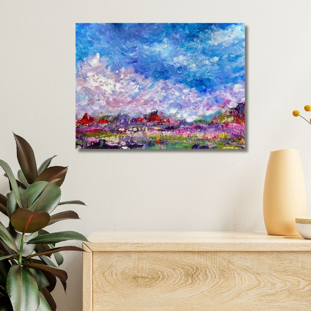 Colorful abstract painting by Ottawa artist Mireille Laroche  on a wall above a wooden console table with decorative items.