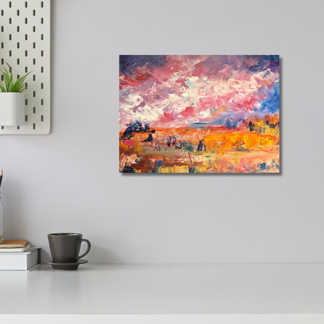 Colorful abstract painting by Ottawa artist Mireille Laroche on a wall above a white surface with a plant and mug.