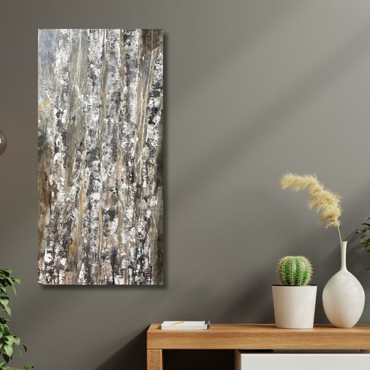 Abstract painting of birch trees in earthy tones by Ottawa artist Mireille Laroche placed on a wall with a wooden table and decorative items below.