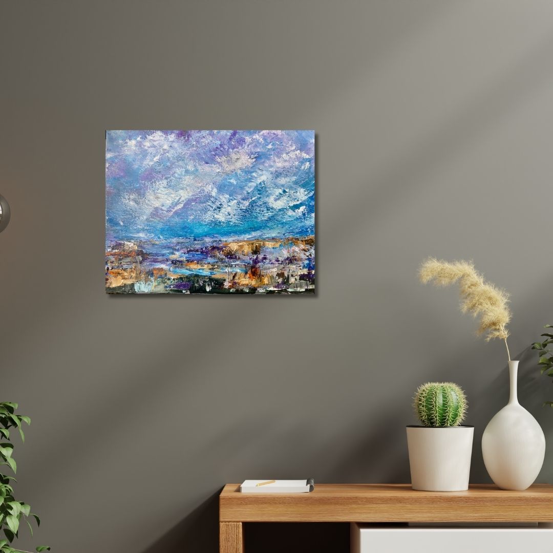 Abstract landscape painting by Ottawa artist on a wall above a wooden console table with decorative items.