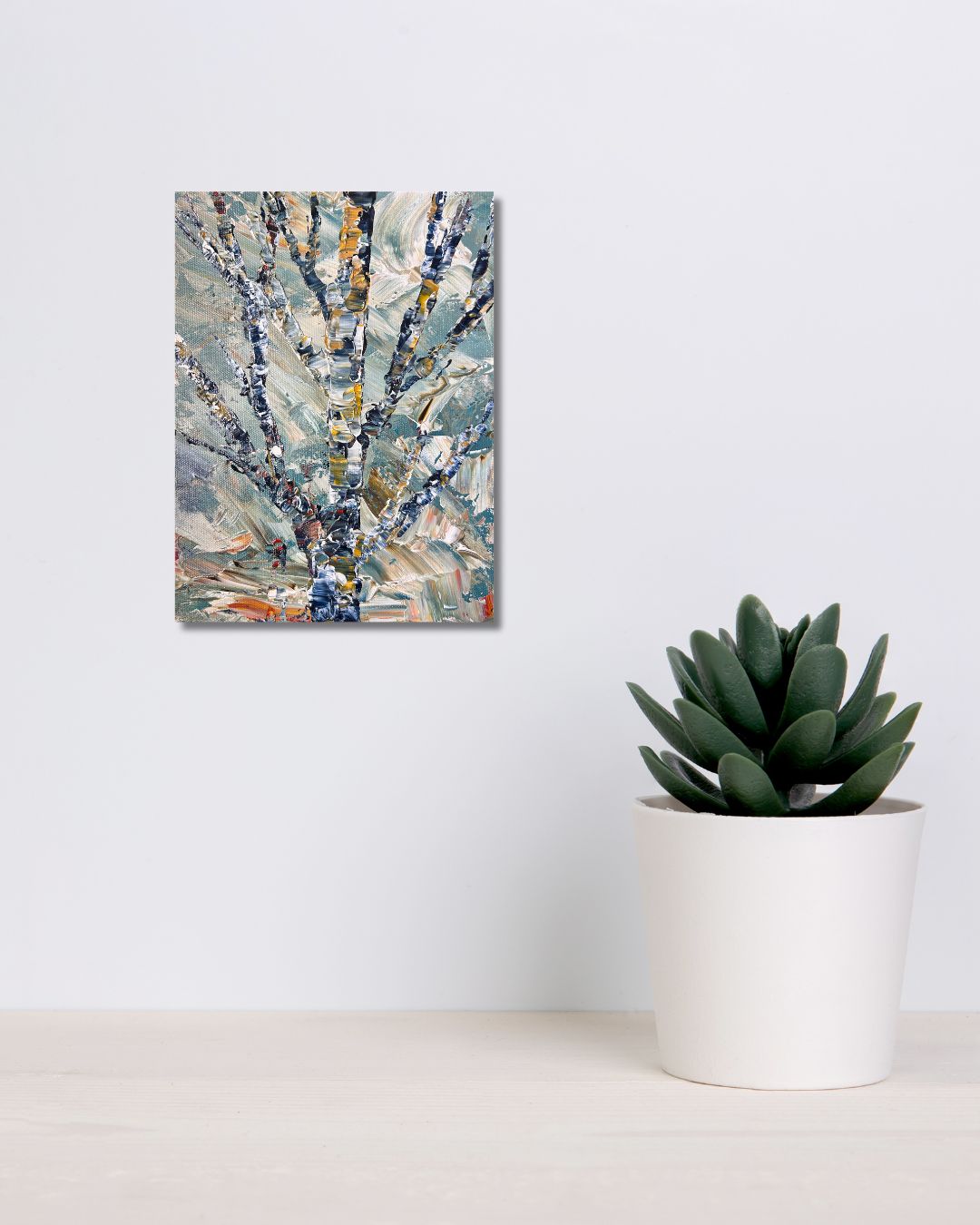 Original 9 by 12 inch acrylic painting on a 1.5 inch deep canvas by Ottawa artist Mireille Laroche  depicting a semi-abstract tree.  Painting on a white wall above a shelf with a plant.