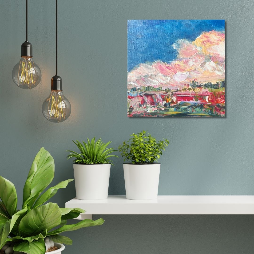Colorful abstract landscape painting by Ottawa artist Mireille Laroche above a shelf and plants