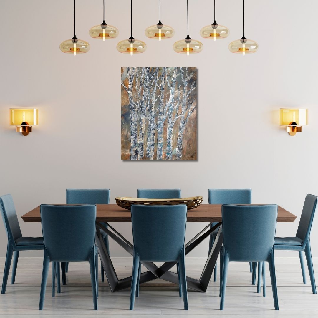 Dining room with a wooden table and blue chairs, featuring a painting  of birches on the wall by Ottawa artist Mireille Laroche