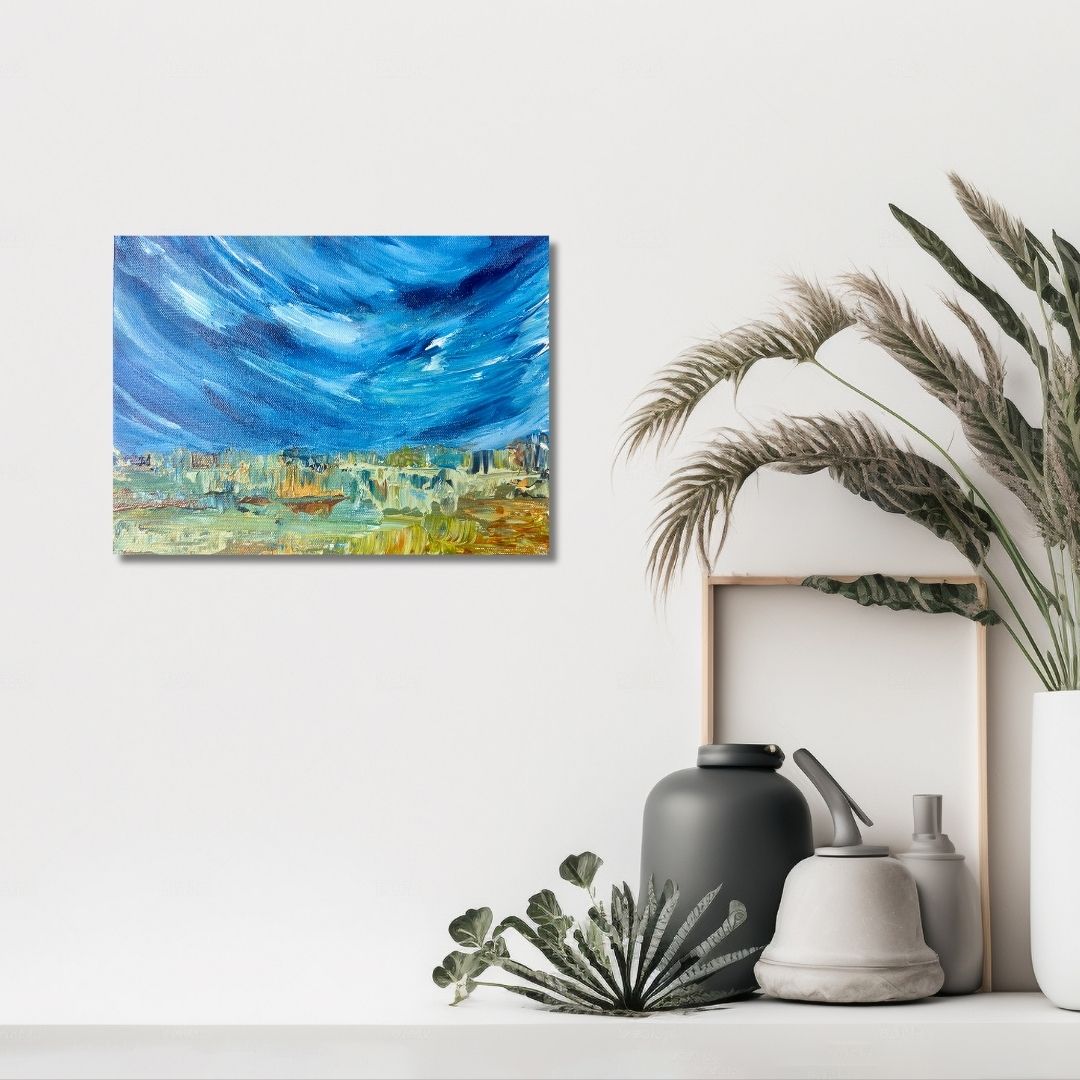 A depiction of a blue sky with clouds by Ottawa artist Mireille Laroche on a white wall, next to decorative items including a vase and plants.
