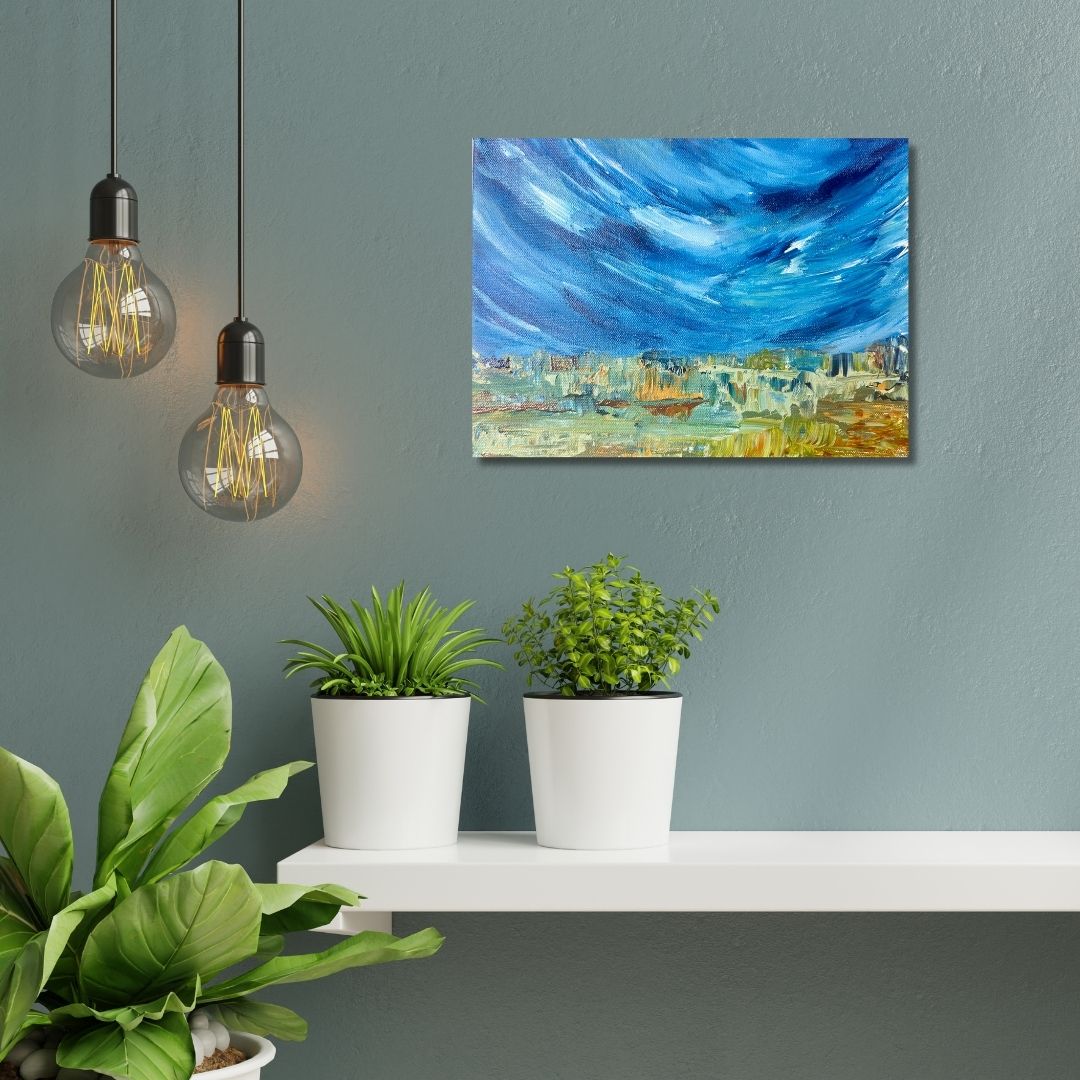 A blue abstract painting by Ottawa artist Mireille Laroche above a shelf, potted plants, and hanging light bulbs.