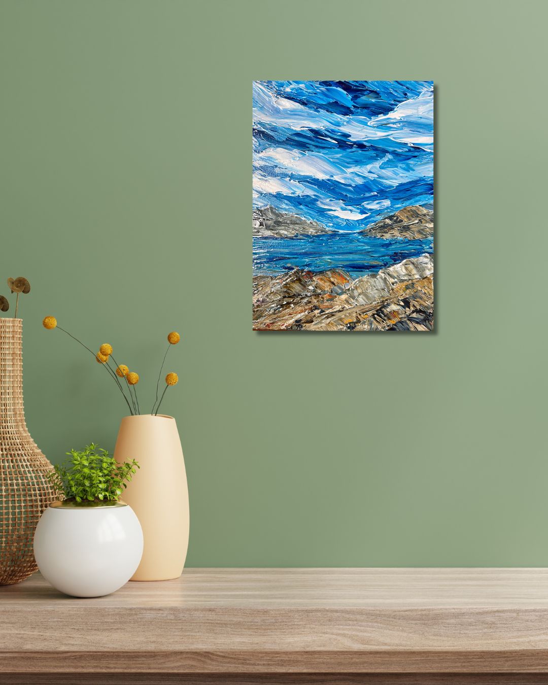 Original 9 by 12 inch acrylic painting on a 1.5 inch deep canvas by Ottawa artist depicting a seaside landscape.  Painting on a green  wall above a shelf with decorative pots.