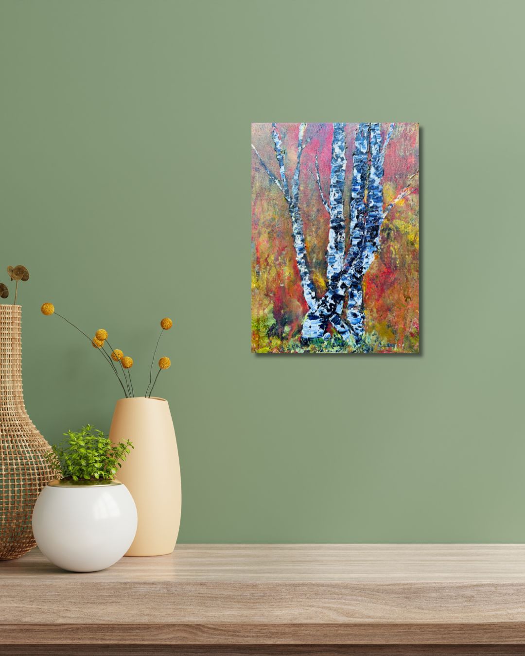 Original acrylic painting by Ottawa artist Mireille Laroche depicting trees with a fall background. Painting on a green wall over a shelf with a decorative pots