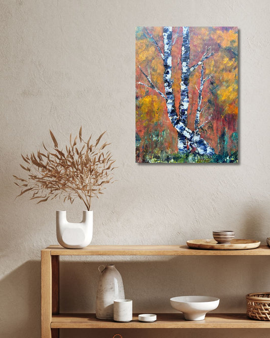 Original acrylic painting by Ottawa artist Mireille Laroche depicting trees with a fall background. Painting on a white wall over a shelf with a green plant. 