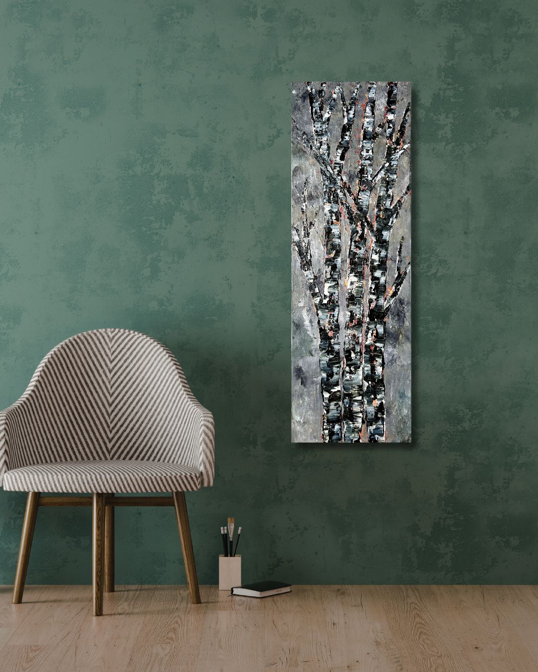 Abstract art piece by Ottawa artist Mireille Laroche on a green wall with a chair and small table below.