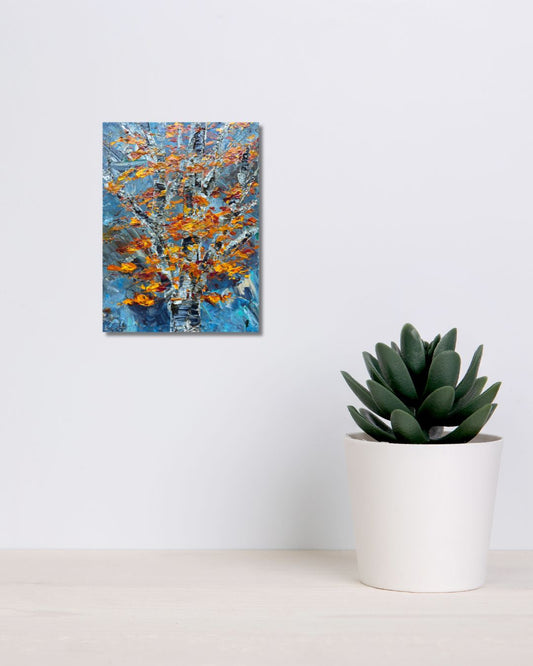 An abstract painting of a tree with blue, white, and orange brushstrokes by Ottawa artist Mireille Laroche, displayed on a white wall next to a potted green succulent.