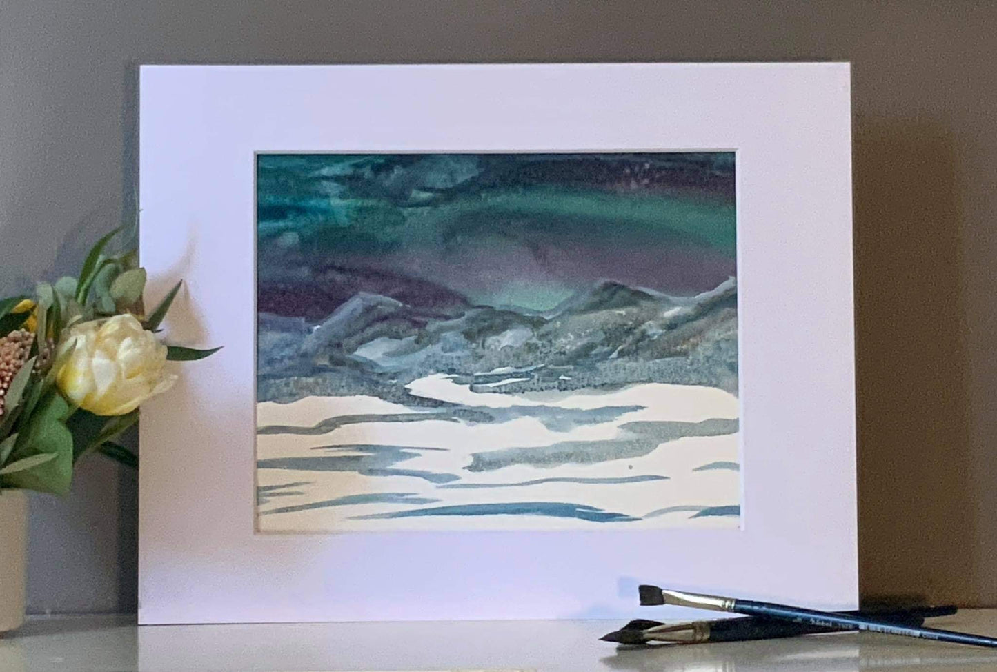 Original watercolor painting by Ottawa-based artist Mireille Laroche entitled Northern Lights, 10 by 8 inch and with mat 14 by 11. Aquarelle originale peinte par Mireille Laroche intitulée Aurores boréales, 10 par 8 pouces, et 14 par 11 pouces avec le passe-partout.